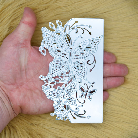 Butterfly edge metal cutting die held vertically in hand to show the overall size and intricate butterfly border design.