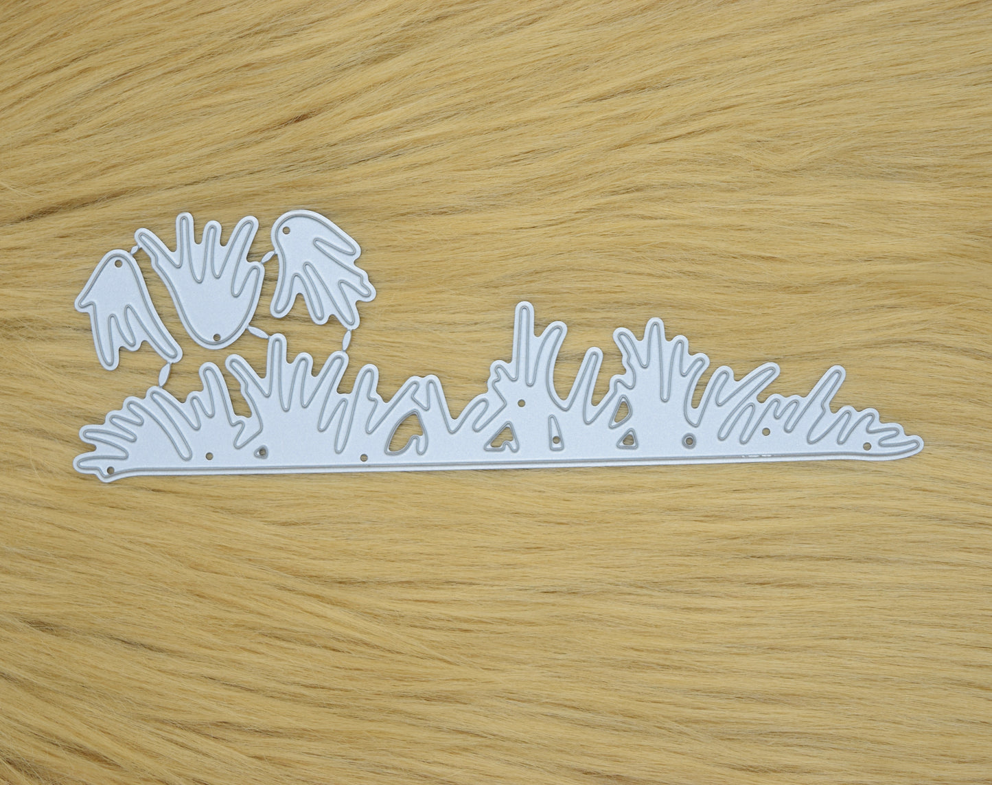 Grass border metal cutting dies set on wooden background