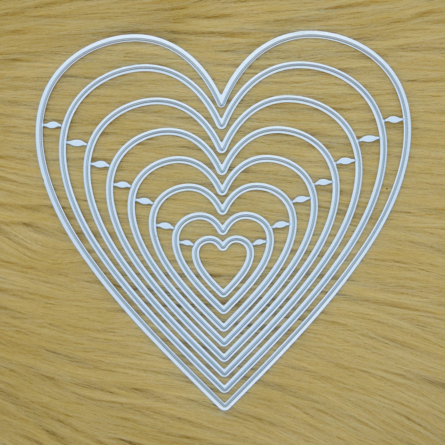 Heart nesting cutting dies set on faux fur surface