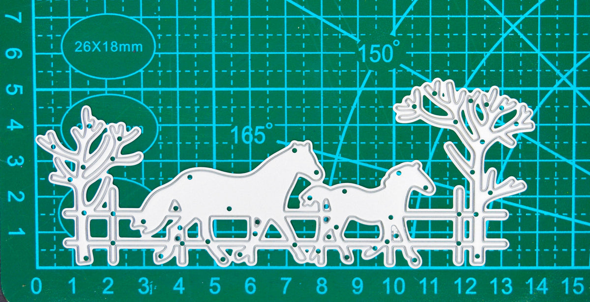 Horse and foal countryside scene metal cutting die displayed on a centimetre cutting mat for size guidance.