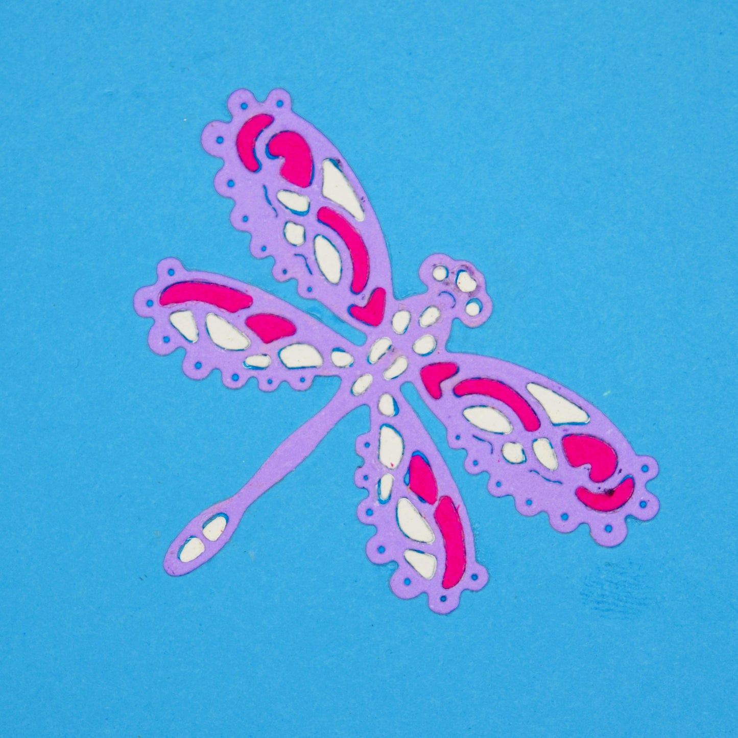 Decorative lace style dragonfly die cut in layered pink purple and white card for card making and papercraft projects
