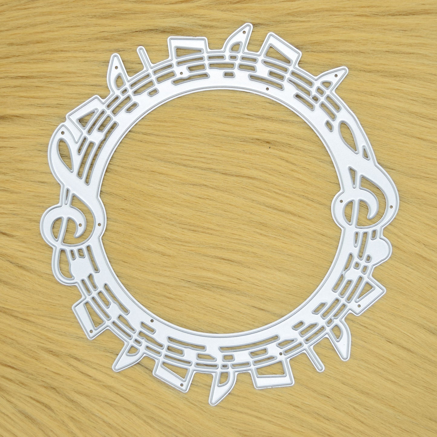 Music notes circle metal cutting die on faux fur background
