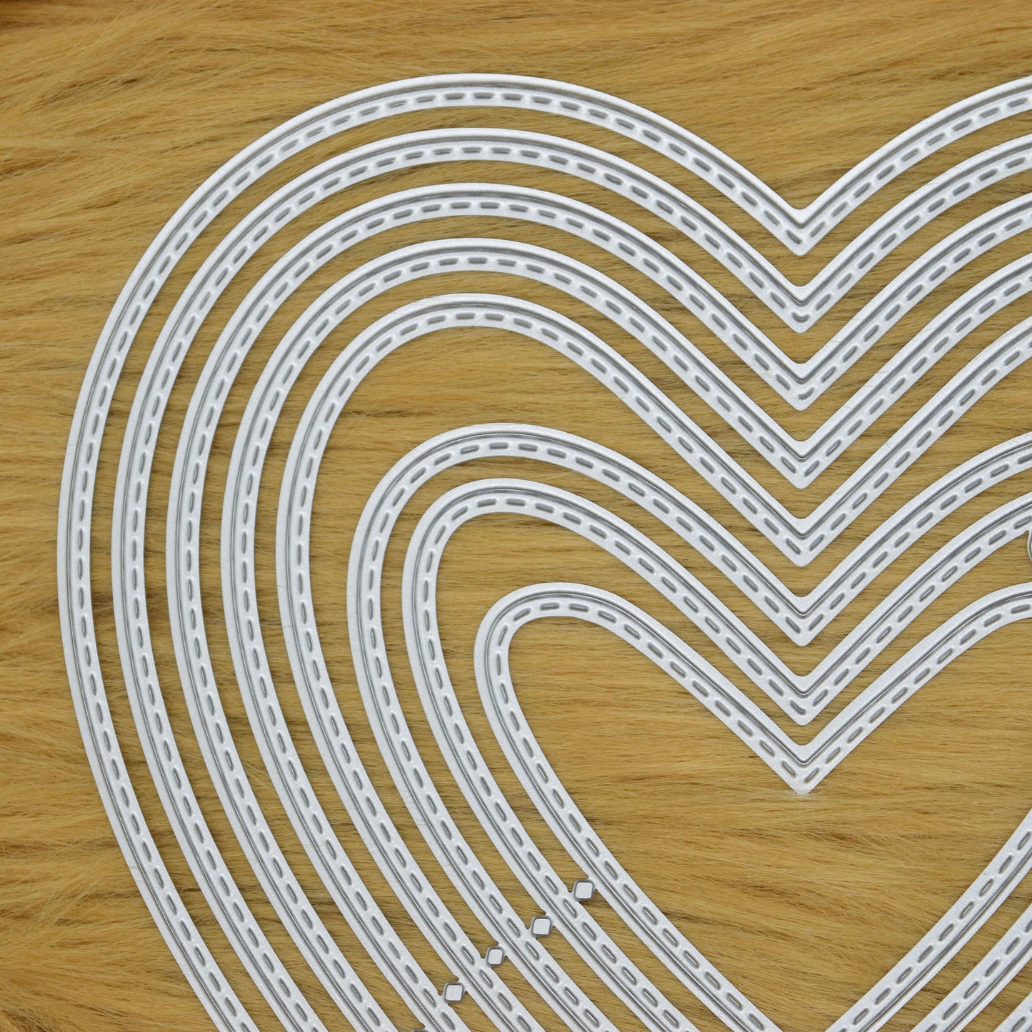 Close up of stitched heart metal cutting dies for papercraft and card making