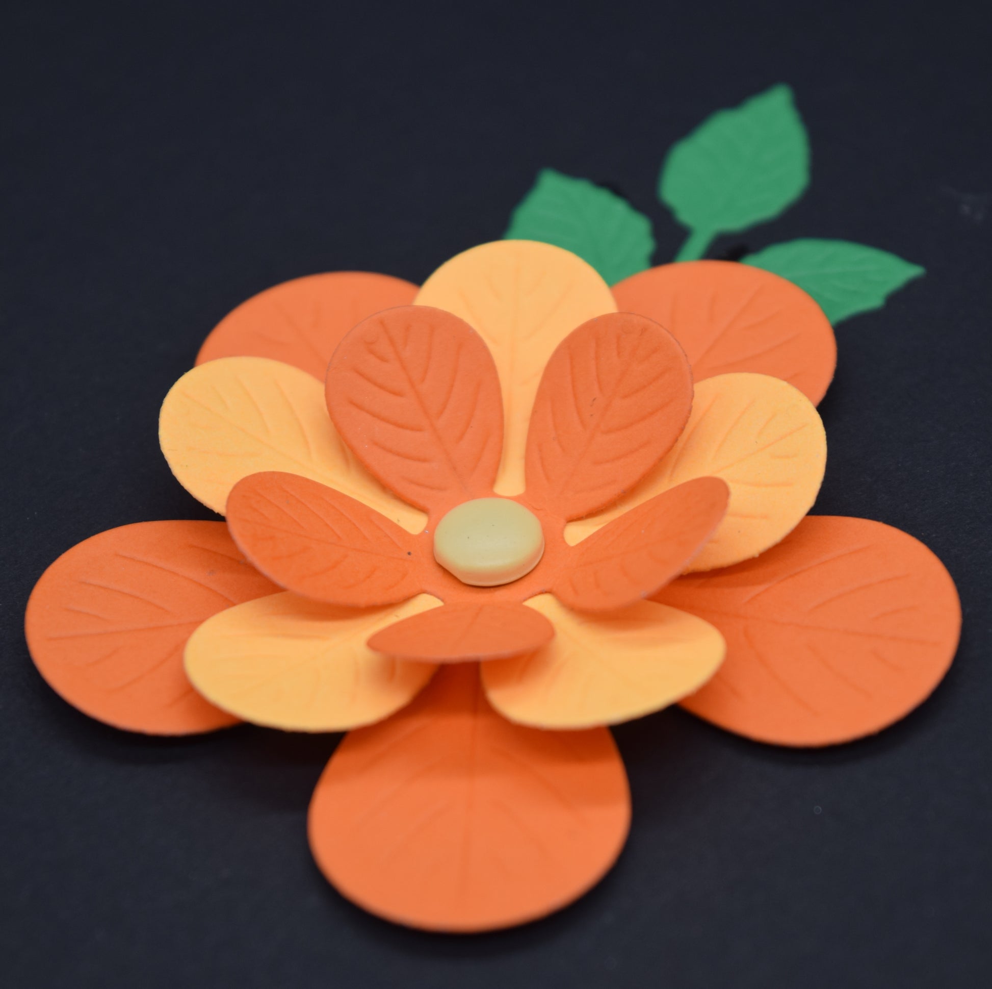 Layered 3D flower die cut with embossed petals in orange and yellow cardstock for card making