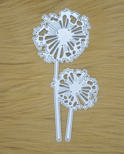 Dandelion metal cutting die displayed on wooden surface for papercraft projects