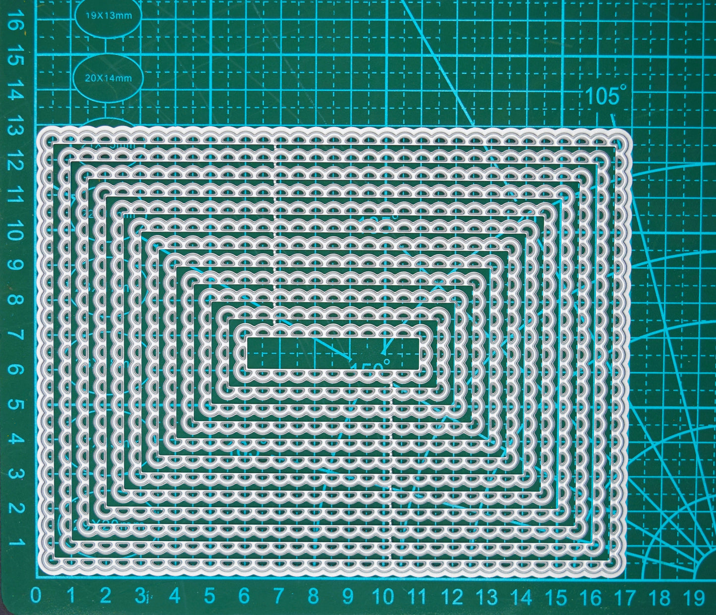 Large A6-friendly rectangle scalloped nesting metal cutting dies on cutting mat showing graduated layering sizes