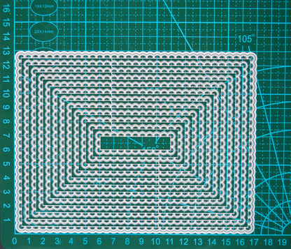 Large A6-friendly rectangle scalloped nesting metal cutting dies on cutting mat showing graduated layering sizes