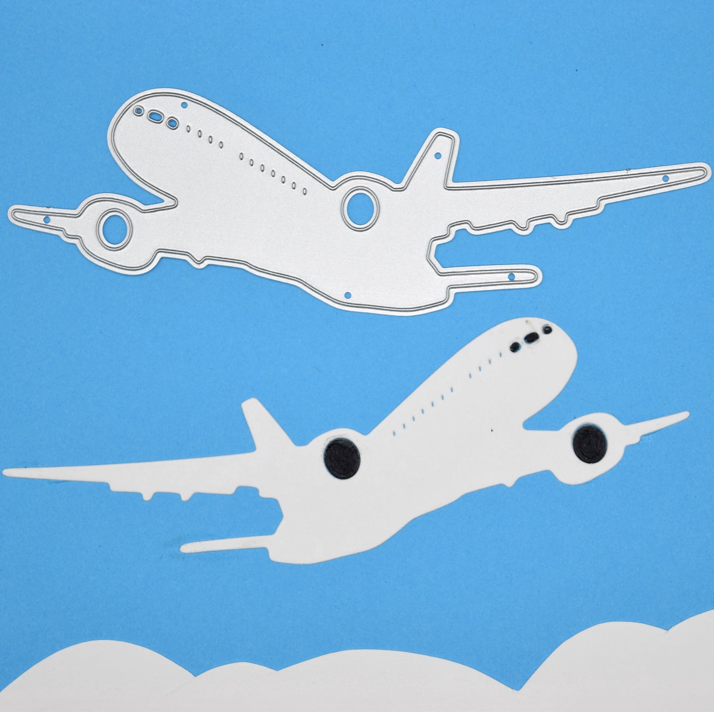 Jet aeroplane die cut with matching metal cutting die on blue sky background for travel themed card making and papercraft projects