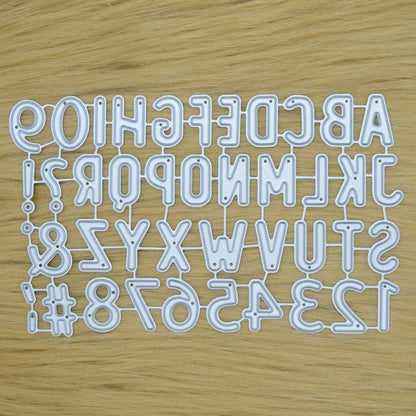 Uppercase alphabet and number dies set on wood background
