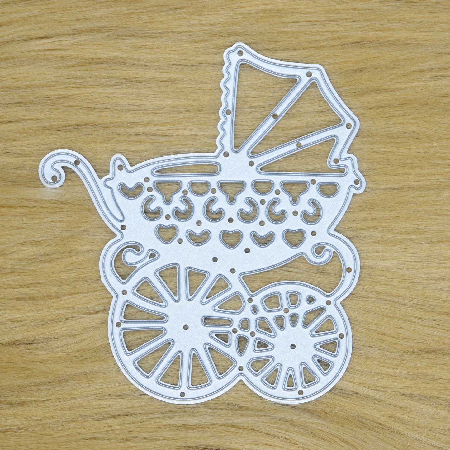 Baby carriage metal cutting die featuring decorative heart and scrollwork details