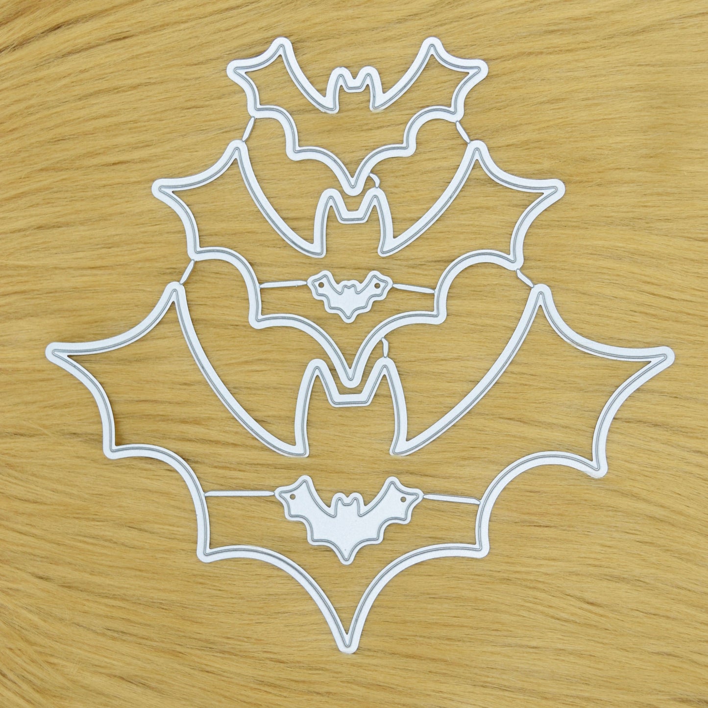 Bat shaped metal cutting dies set arranged on soft faux fur background