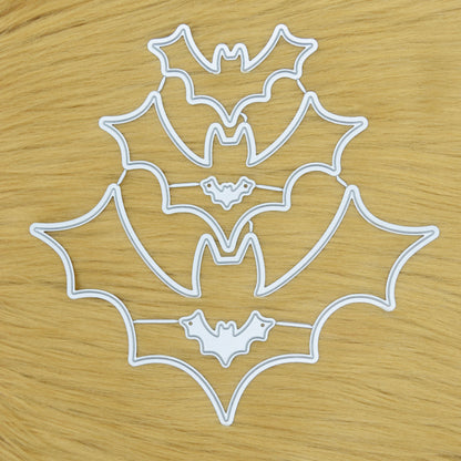 Bat shaped metal cutting dies set arranged on soft faux fur background