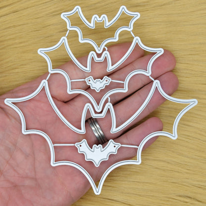 Bat nesting metal cutting dies held in hand showing size and scale