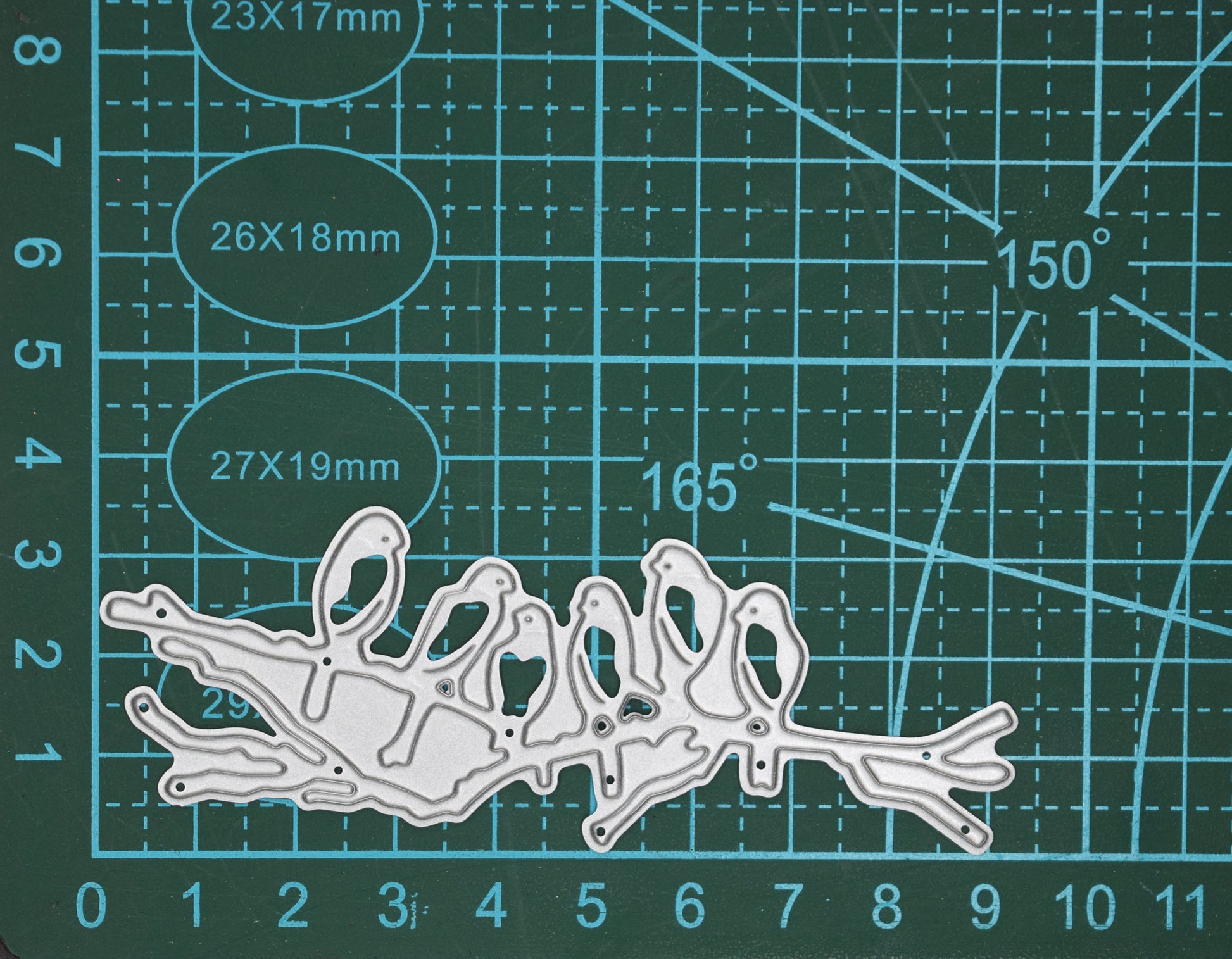 Birds on branch metal cutting die on cutting mat showing size
