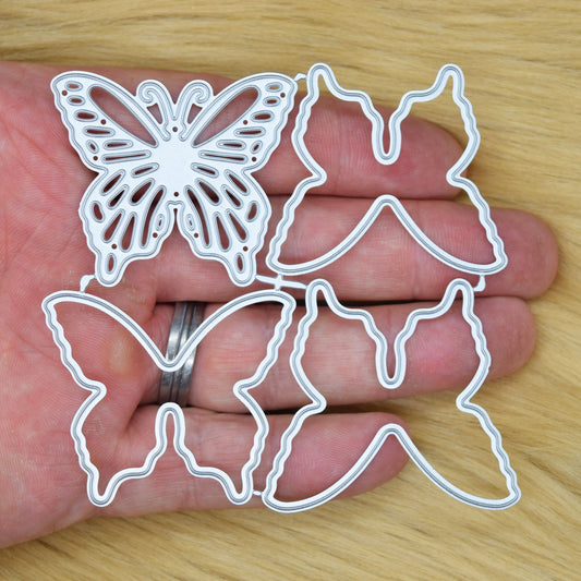 Butterfly metal cutting dies held in hand showing size and intricate wing cut detail