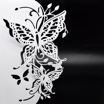 Close-up of the finished 3D butterfly edge with intricate wing cut-outs, foliage and decorative flourishes on white card.