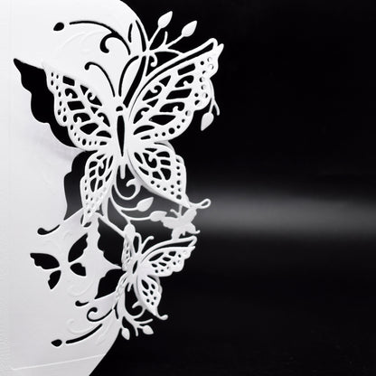 Finished white butterfly edge card showing the raised 3D effect created by the detailed butterfly metal cutting die.