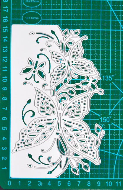 Butterfly edge metal cutting die displayed on a cutting mat to show its approximate size for card making and papercraft.