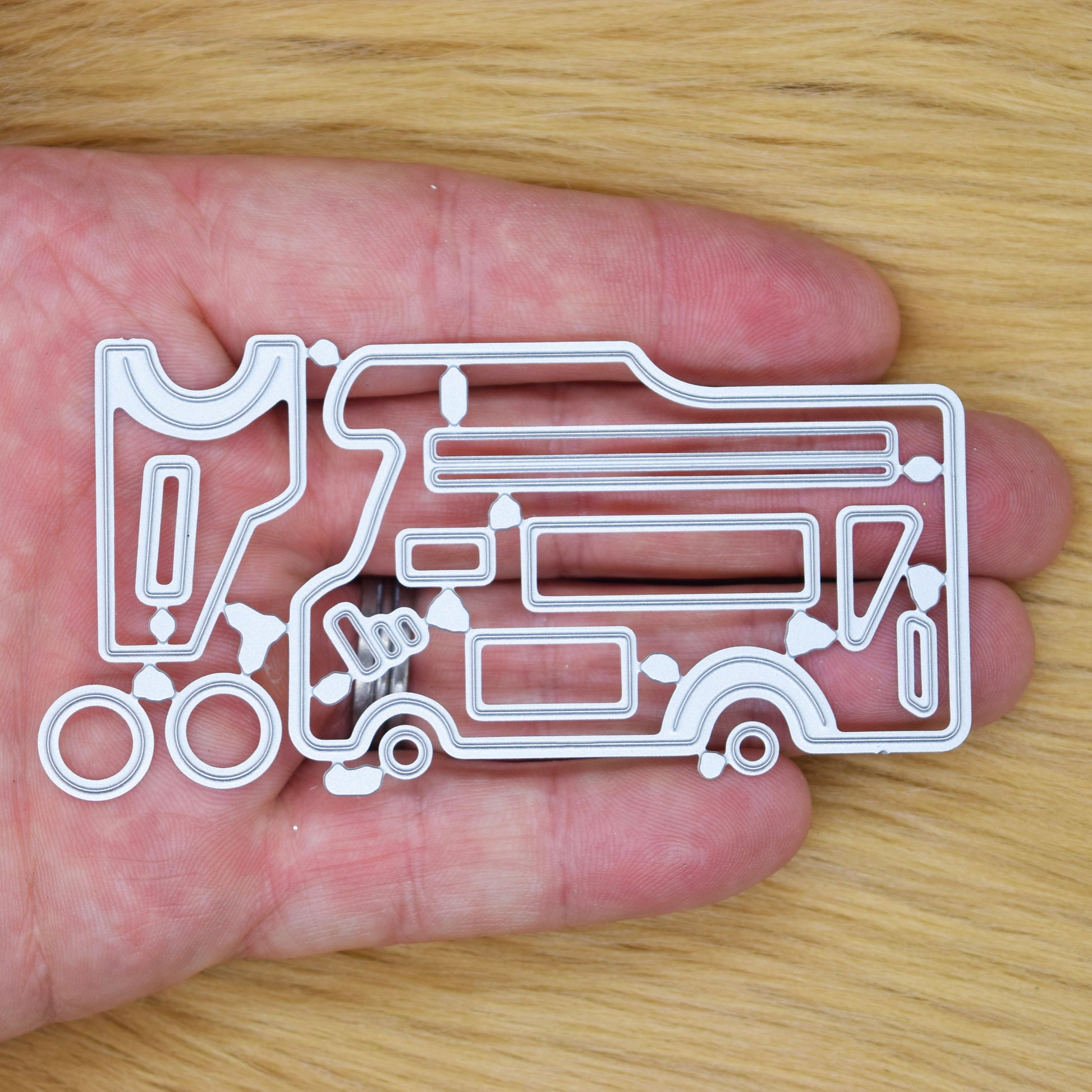 Camper van metal cutting dies set shown in hand for size reference