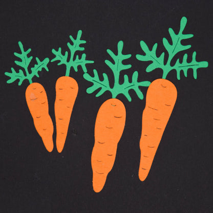 Finished carrot die cut shapes in orange and green card created using carrot metal cutting dies for gardening themed crafts
