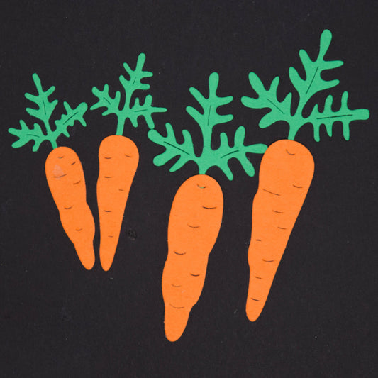 Finished carrot die cut shapes in orange and green card created using carrot metal cutting dies for gardening themed crafts