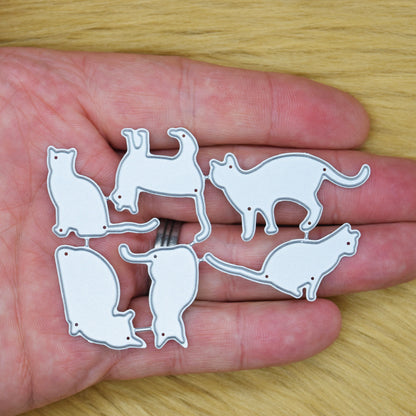 Set of six cat silhouette metal cutting dies held in hand to show their size and different feline poses