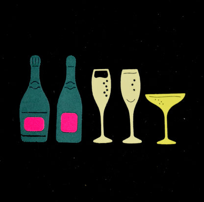 Green champagne bottles with pink labels and three yellow glass cuts on black, made using metal cutting dies for celebration papercraft.