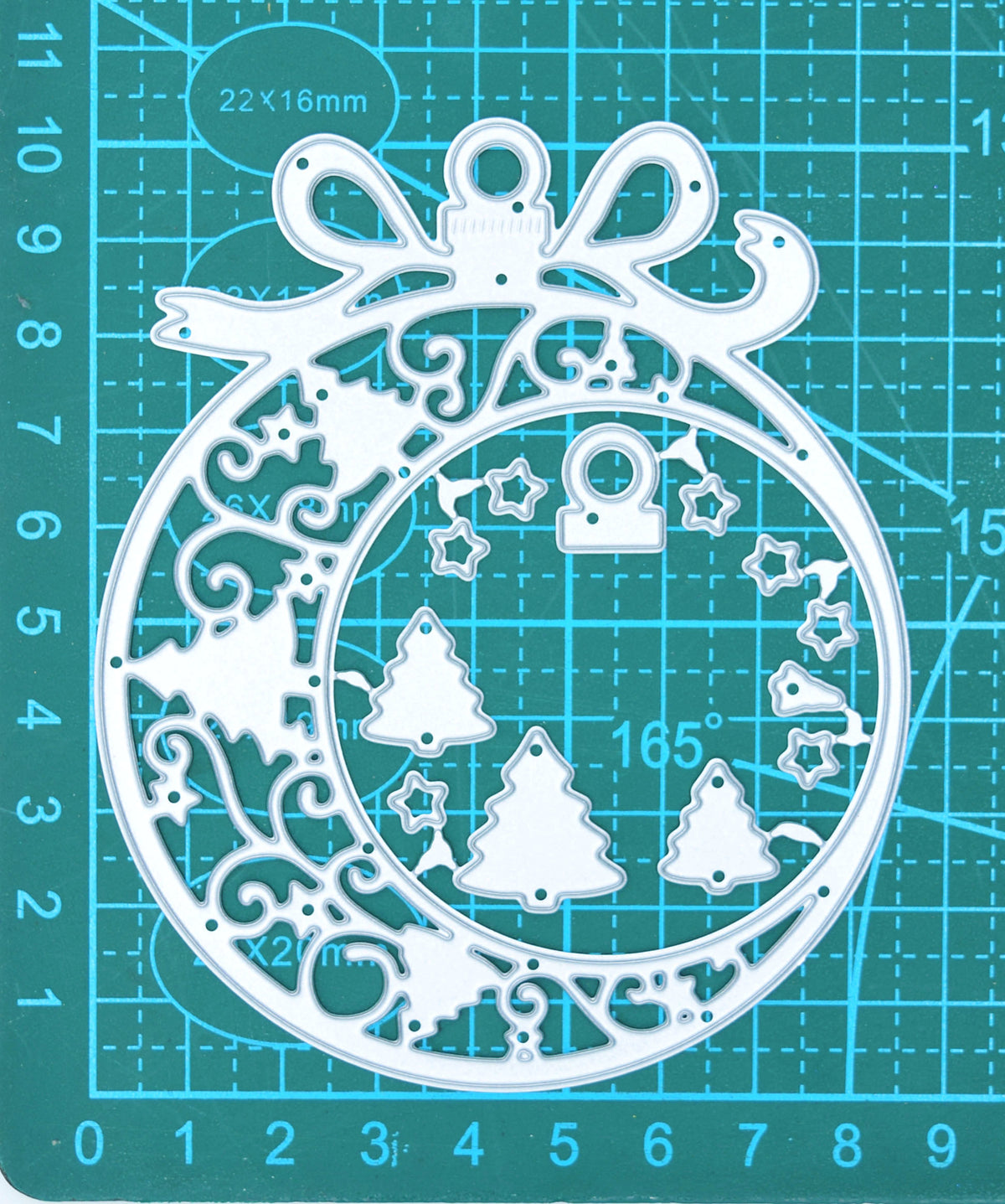 Large Christmas bauble frame metal cutting dies on a centimetre cutting mat, showing the overall size and smaller layering pieces.