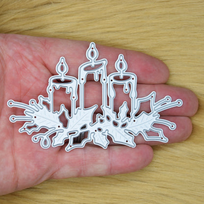 Christmas Candles & Holly metal cutting die shown in hand to demonstrate the size for Christmas card making and paper crafting.