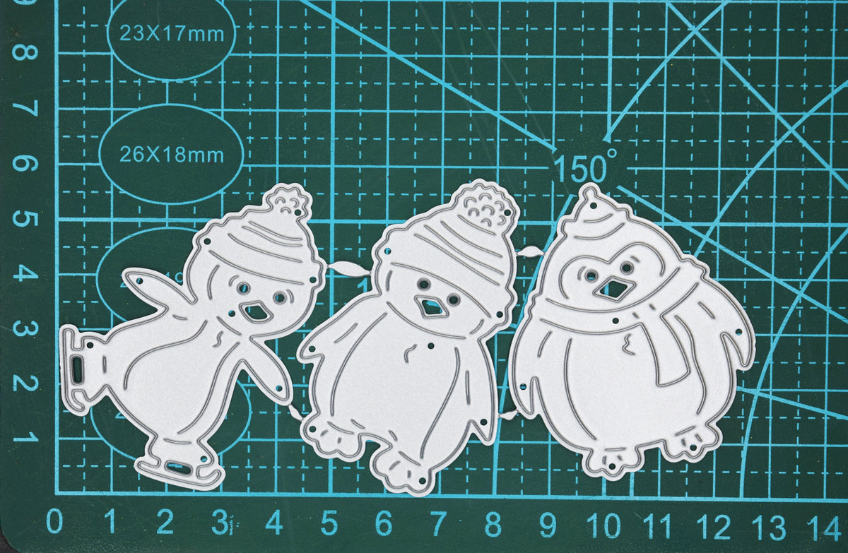 Christmas penguin metal cutting dies set shown on measuring mat for size reference