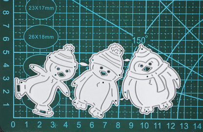 Christmas penguin metal cutting dies set shown on measuring mat for size reference
