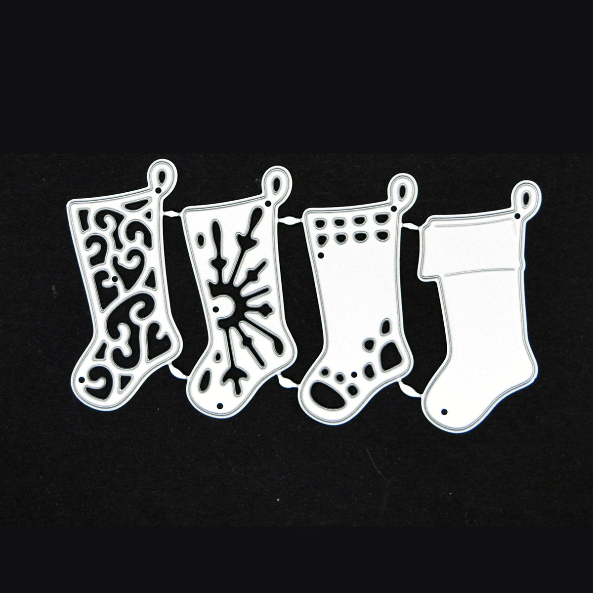 Four Christmas stocking metal cutting dies on black, showing swirl, snowflake, patterned and plain cuffed designs.