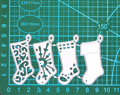 Four Christmas stocking metal cutting dies on a centimetre cutting mat, showing the size of the joined set.