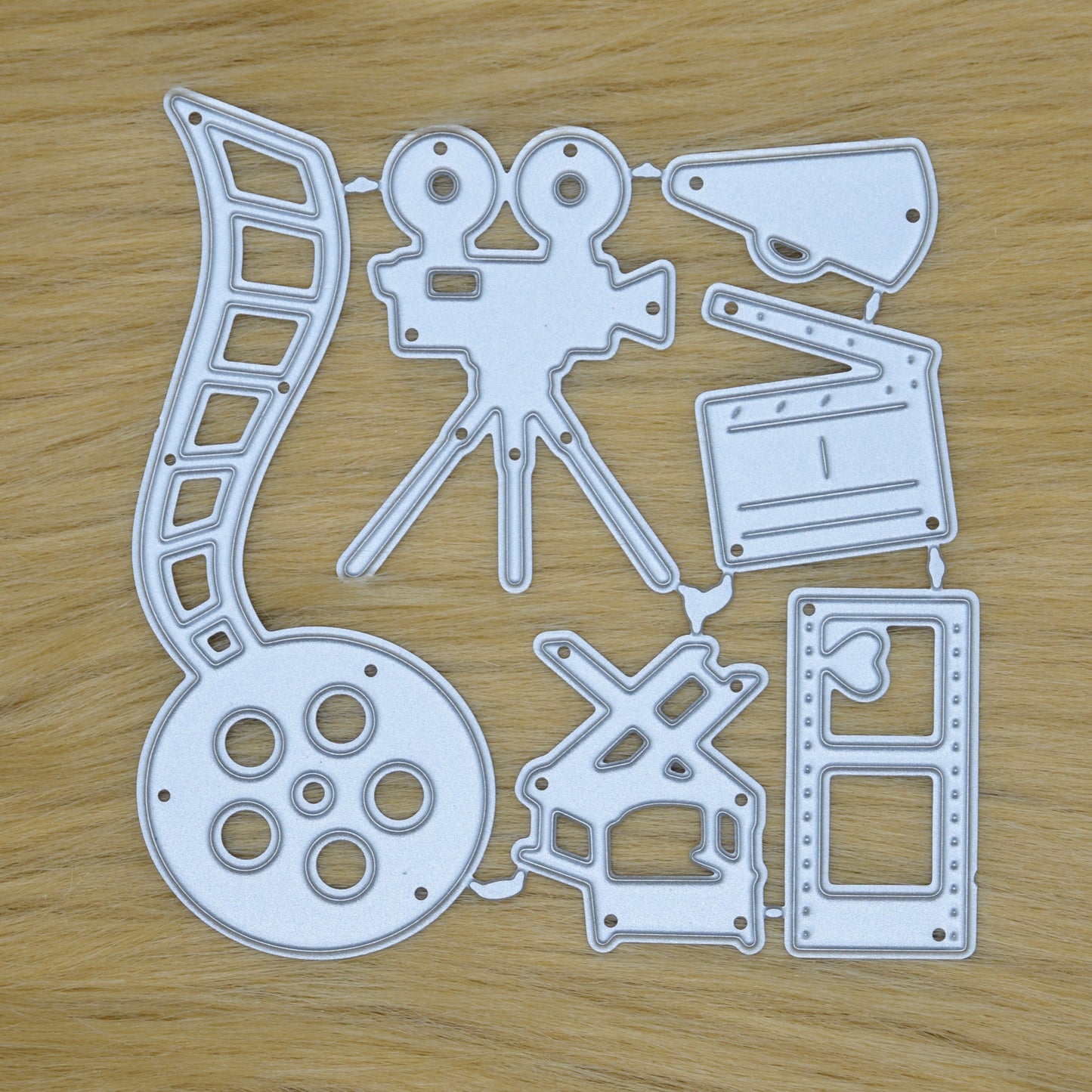 Cinema themed metal cutting die set with film reel movie camera clapperboard and director chair for handmade cards and scrapbooking