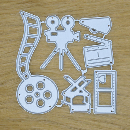 Cinema themed metal cutting die set with film reel movie camera clapperboard and director chair for handmade cards and scrapbooking
