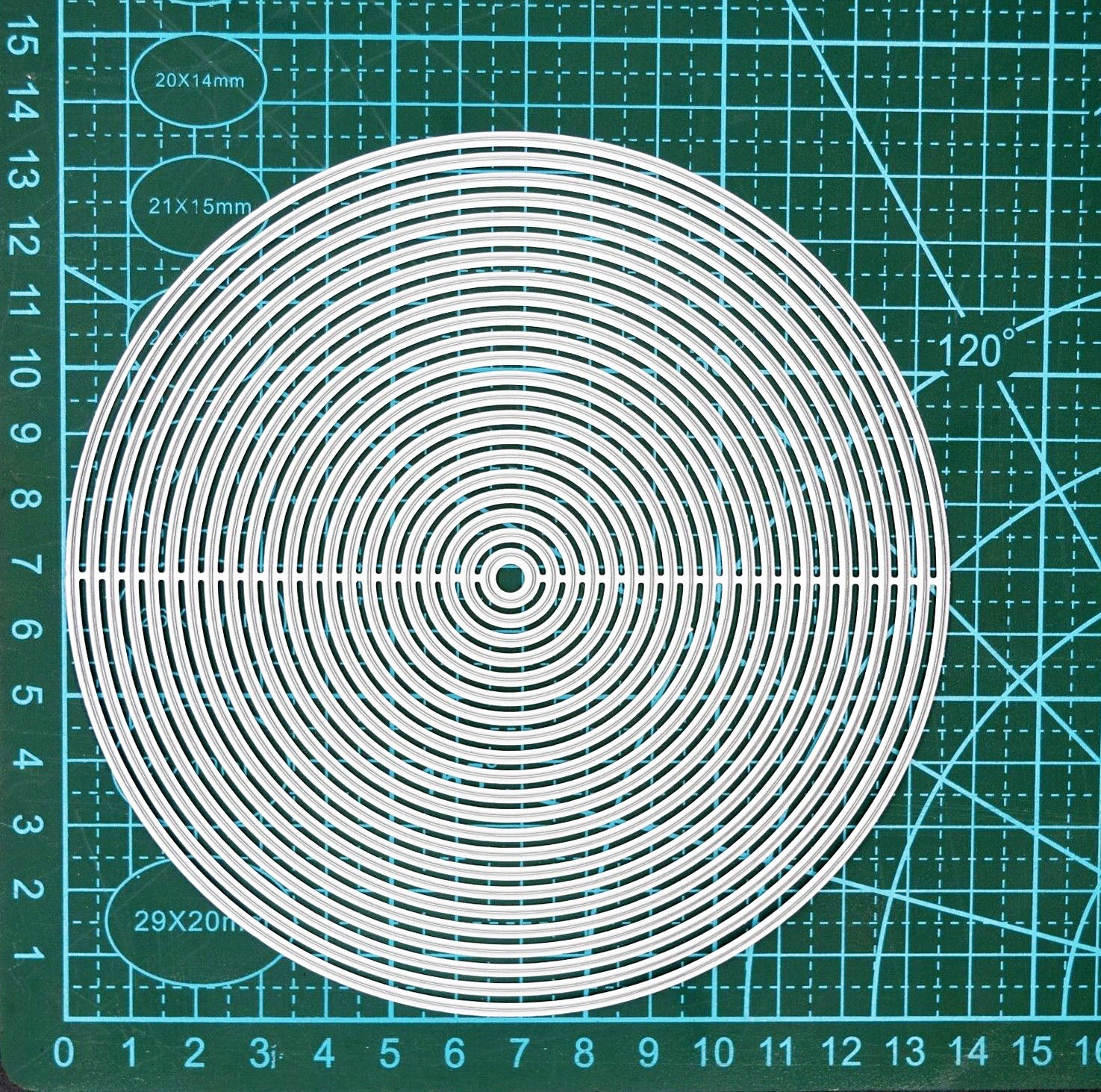 Circle nesting metal cutting dies placed on cutting mat for scale