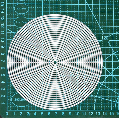 Circle nesting metal cutting dies placed on cutting mat for scale