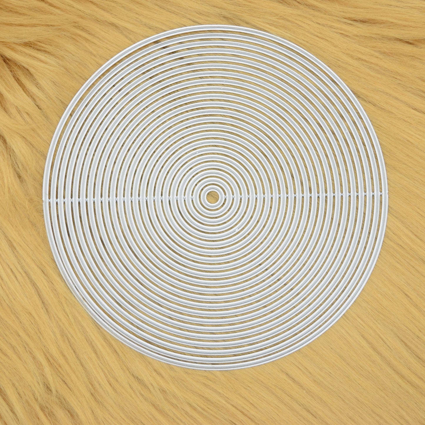 Circle nesting metal cutting dies set on soft faux fur background