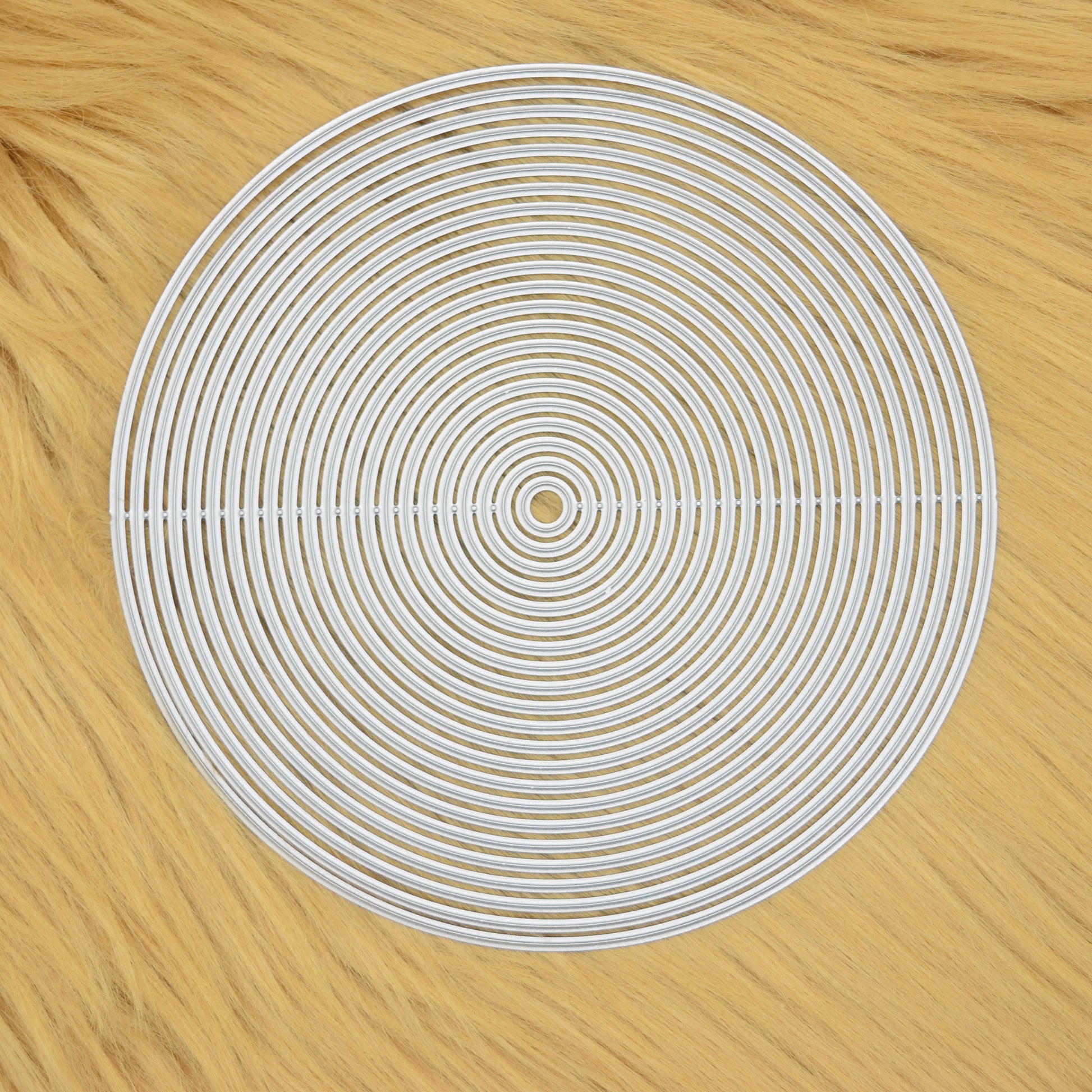 Circle nesting metal cutting dies set on soft faux fur background