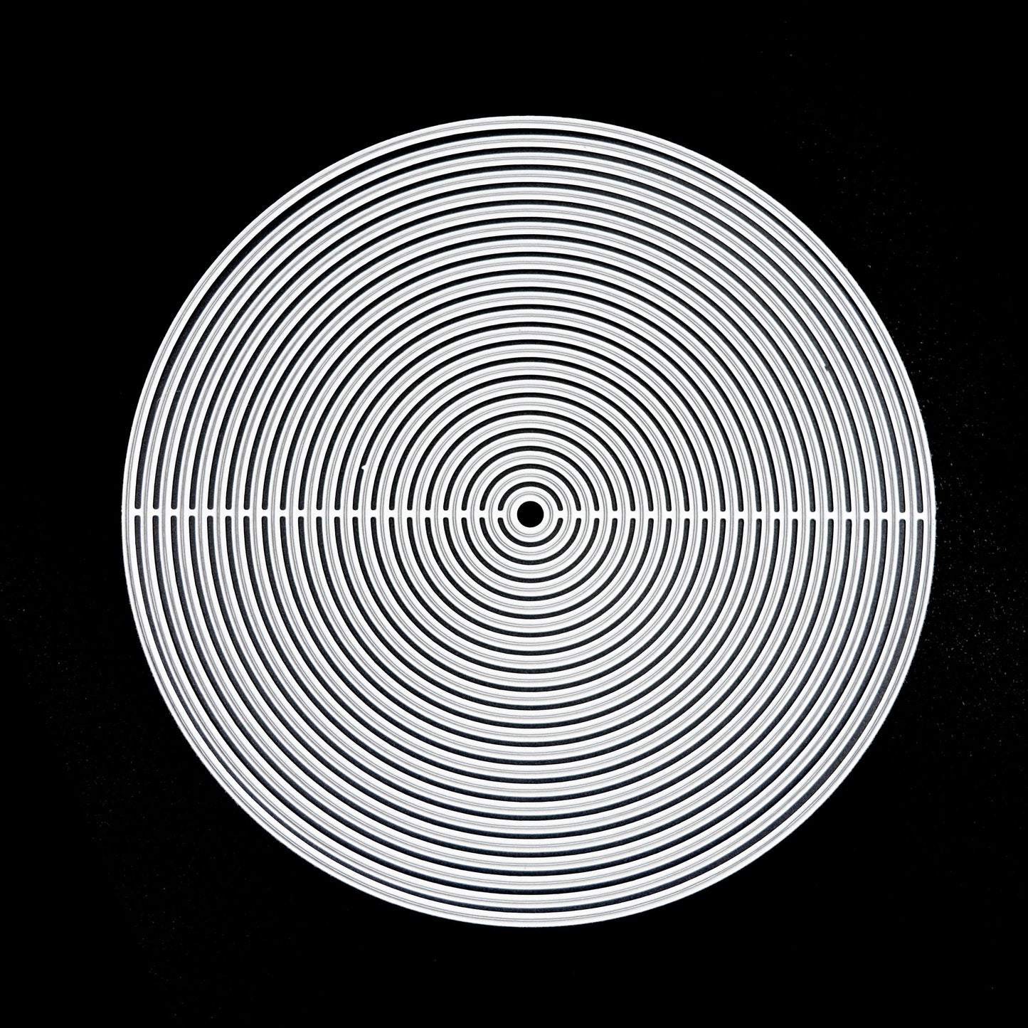 Full set of circle nesting metal cutting dies arranged on black background