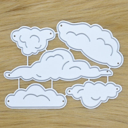 Cloud metal cutting dies set on faux fur background showing five cloud shapes