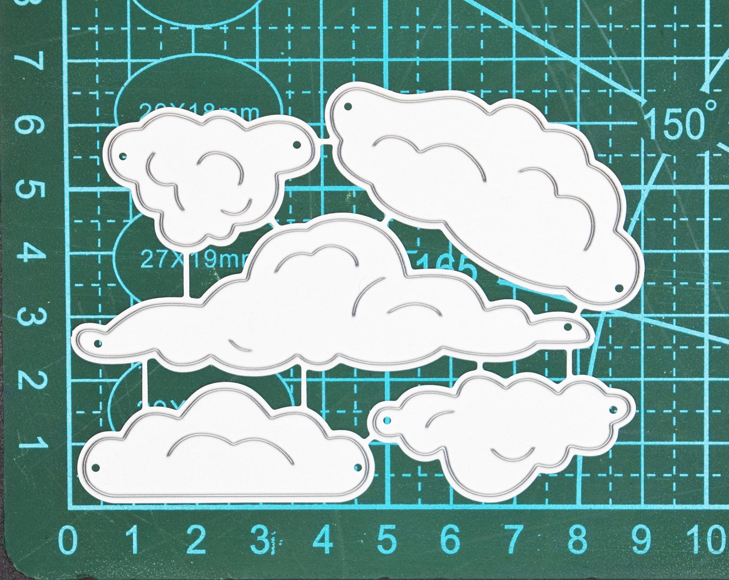 Cloud metal cutting dies set on cutting mat showing size and shape variation