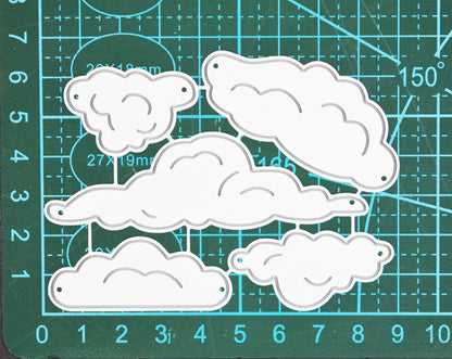 Cloud metal cutting dies set on cutting mat showing size and shape variation