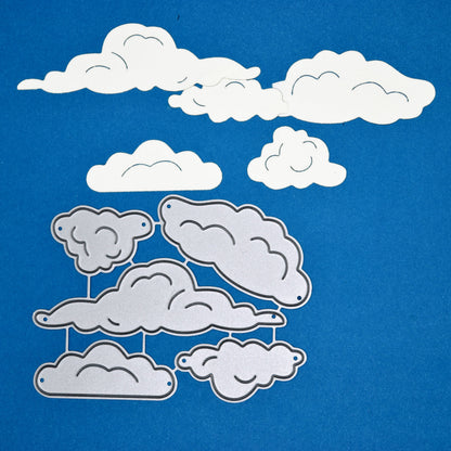 Cloud metal cutting dies set with cut paper clouds on blue background for card making