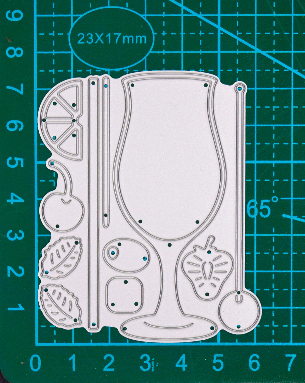 Cocktail glass and garnish metal cutting die set shown on a cutting mat for scale.