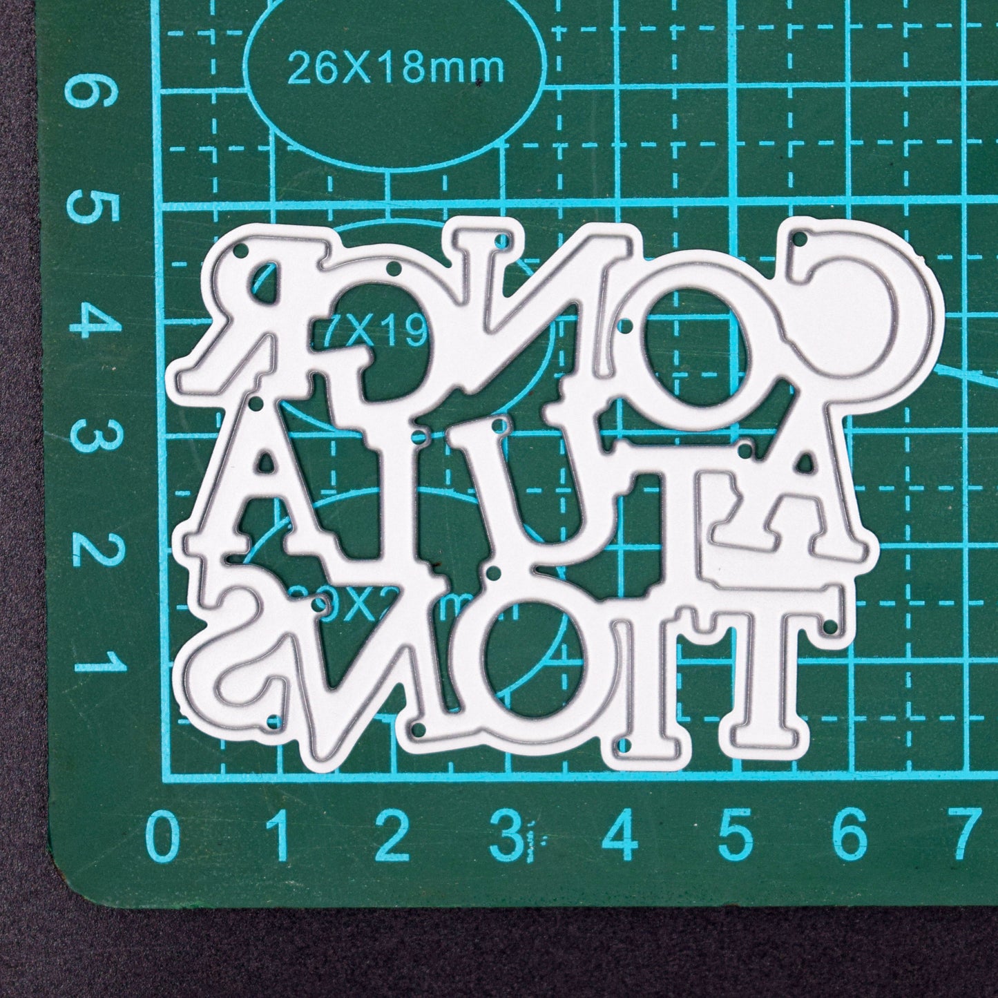 Congratulations metal cutting die on cutting mat showing measurements