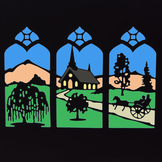 Coloured countryside window scene die cut showing a church, weeping willow, trees, hills and horse-drawn cart within three pointed arch panels.