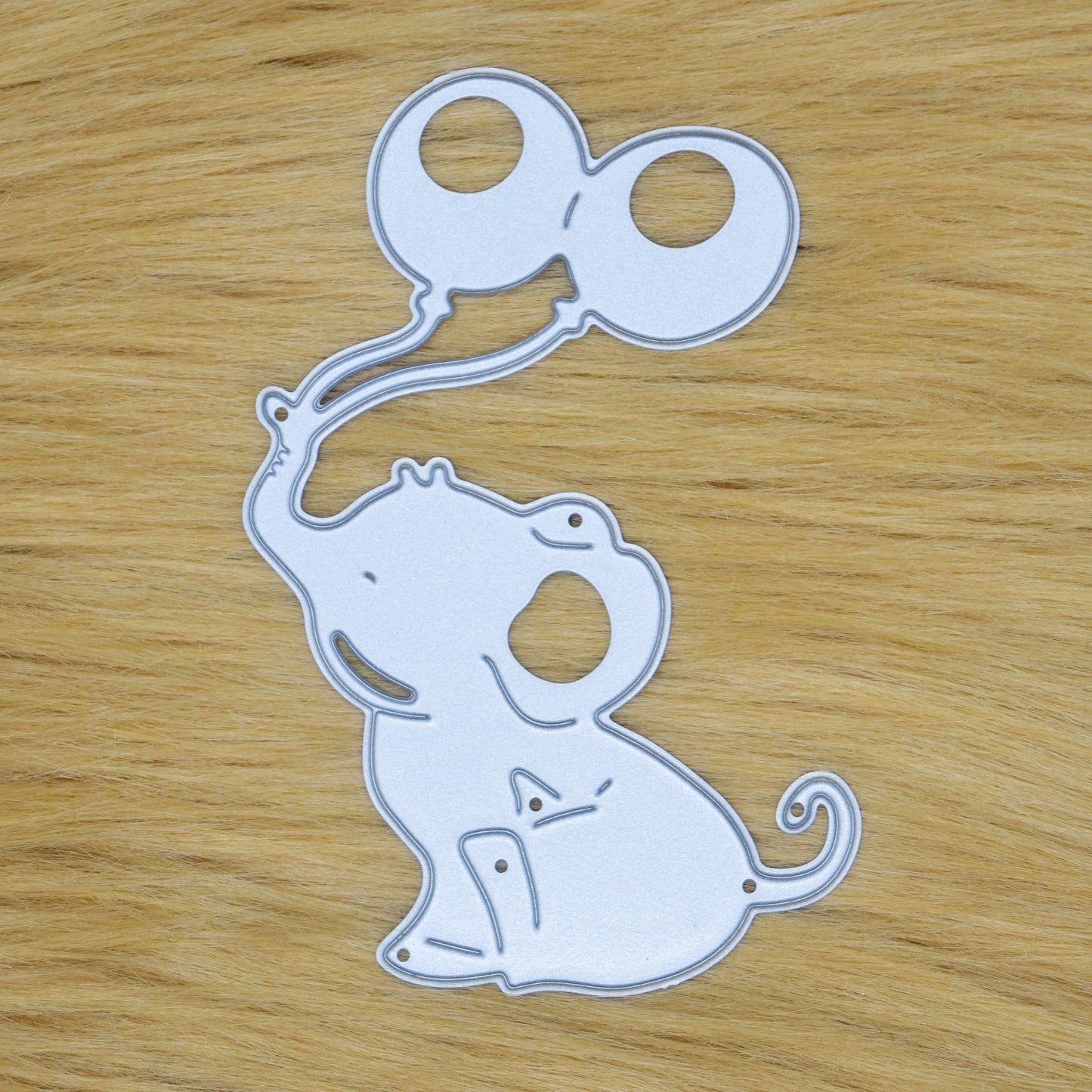 Cute baby elephant metal cutting die on faux fur background