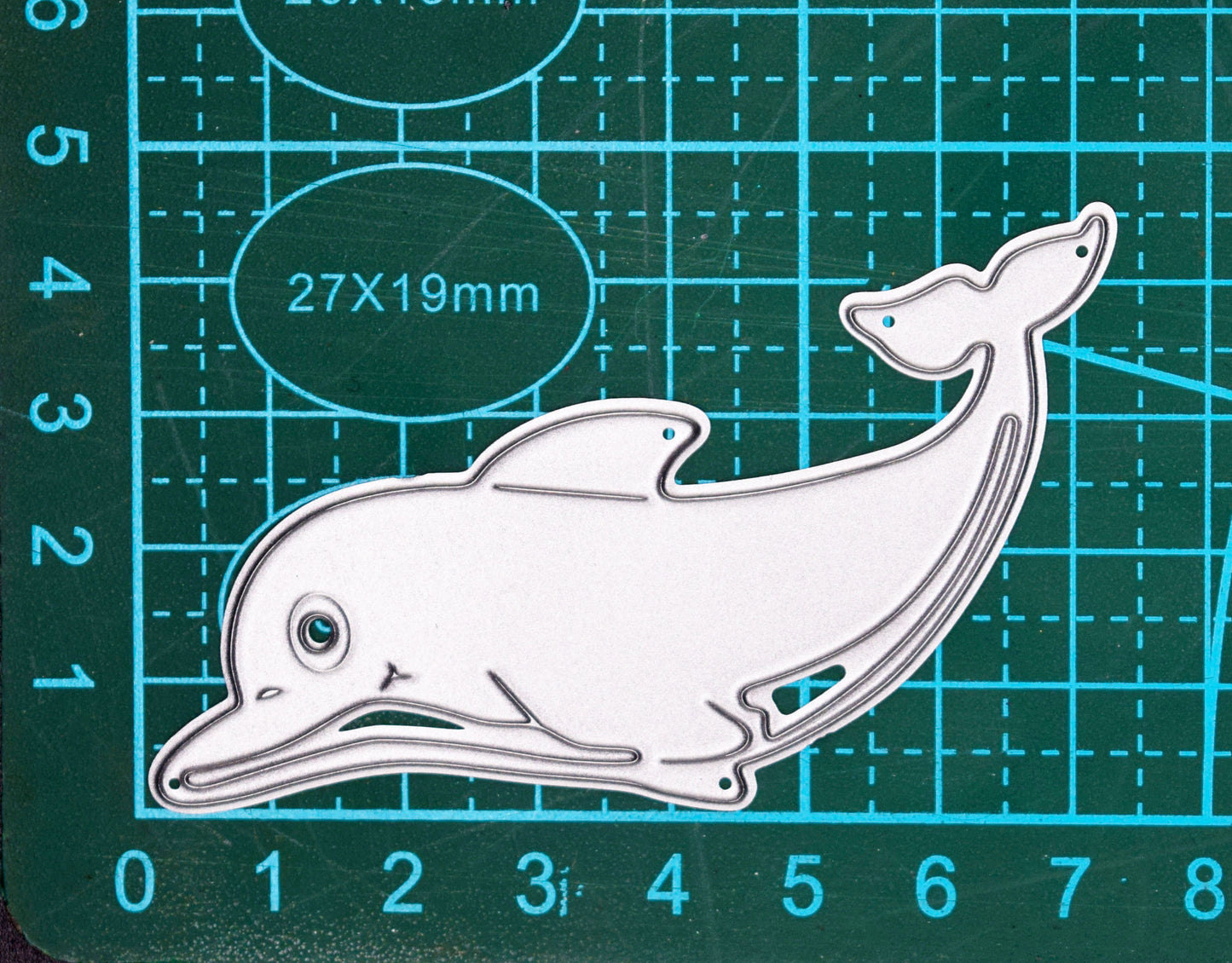 Dolphin metal cutting die on cutting mat showing approximate size and detail lines