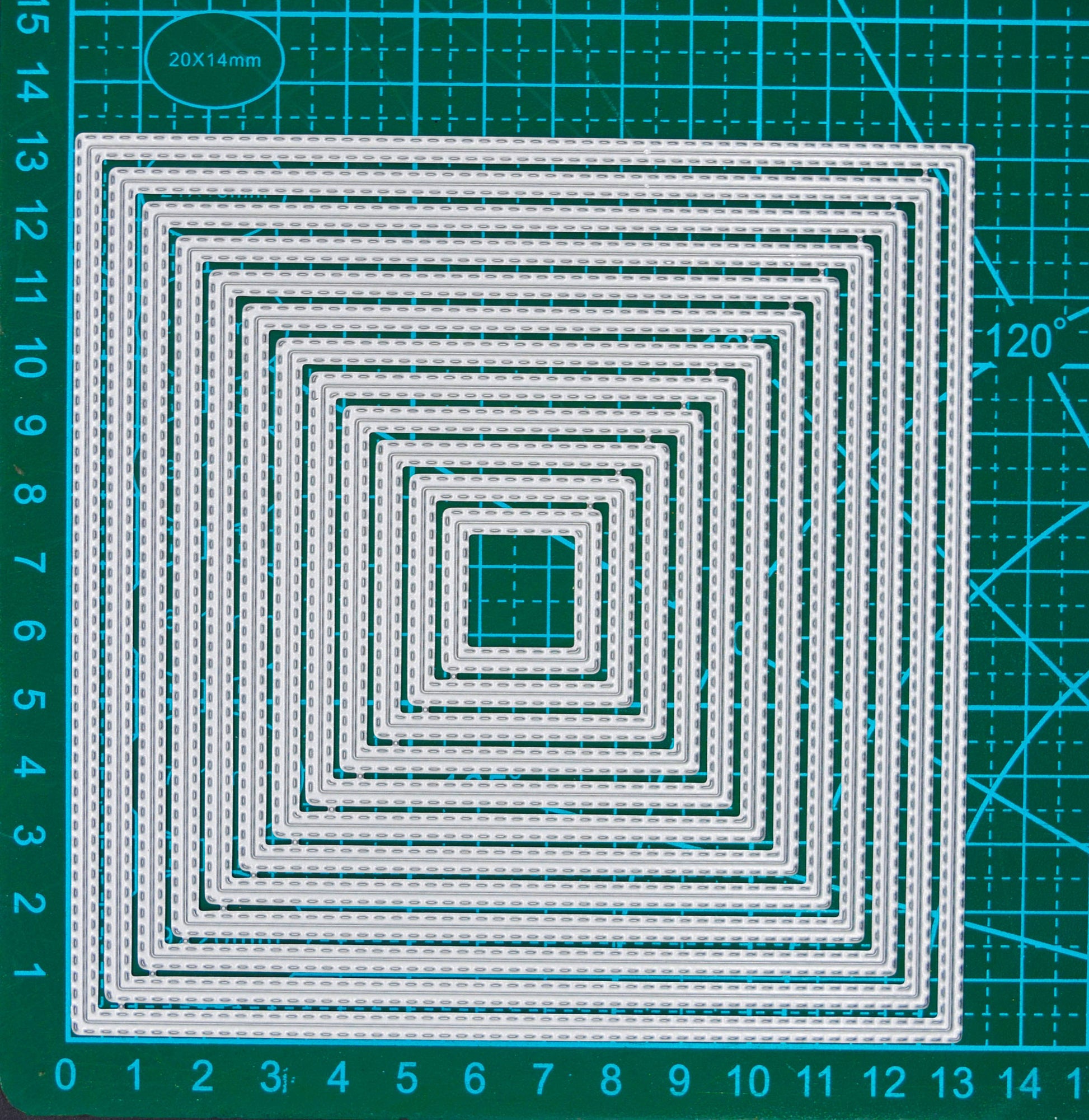 Set of 12 double stitched square metal cutting dies displayed on a centimetre cutting mat for size guidance.